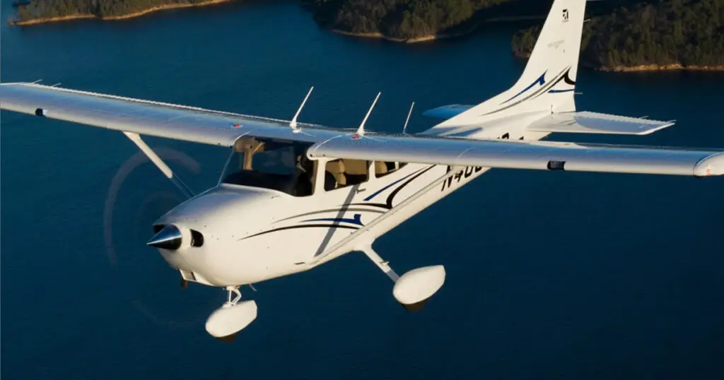 Airplane flying over lake