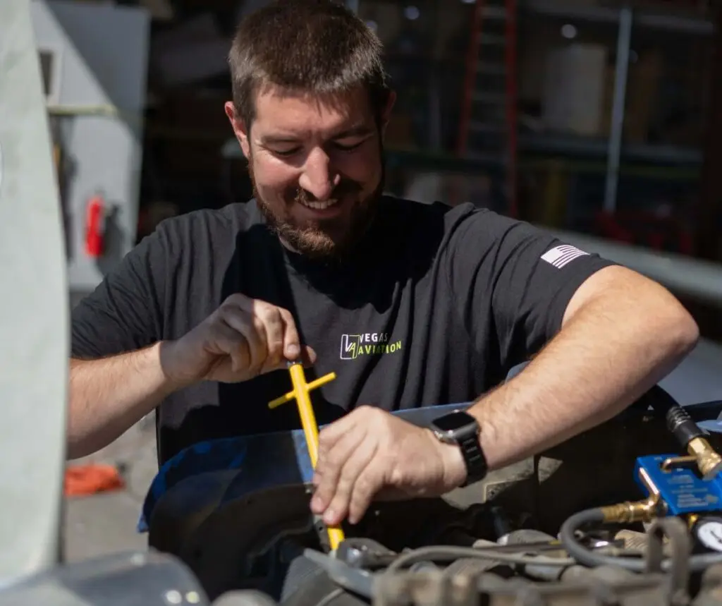 Vegas Aviation mechanic working on an aircraft's engine