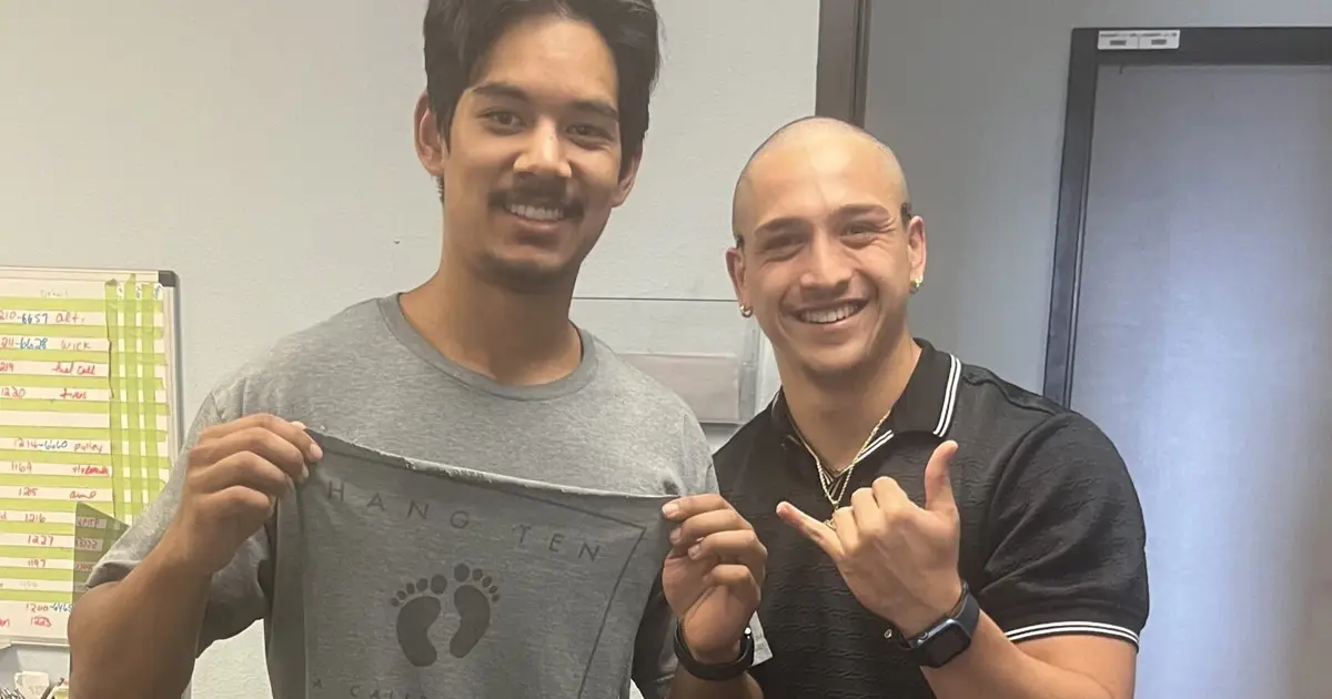 Pilot Student holding a cut shirt after his first solo flight