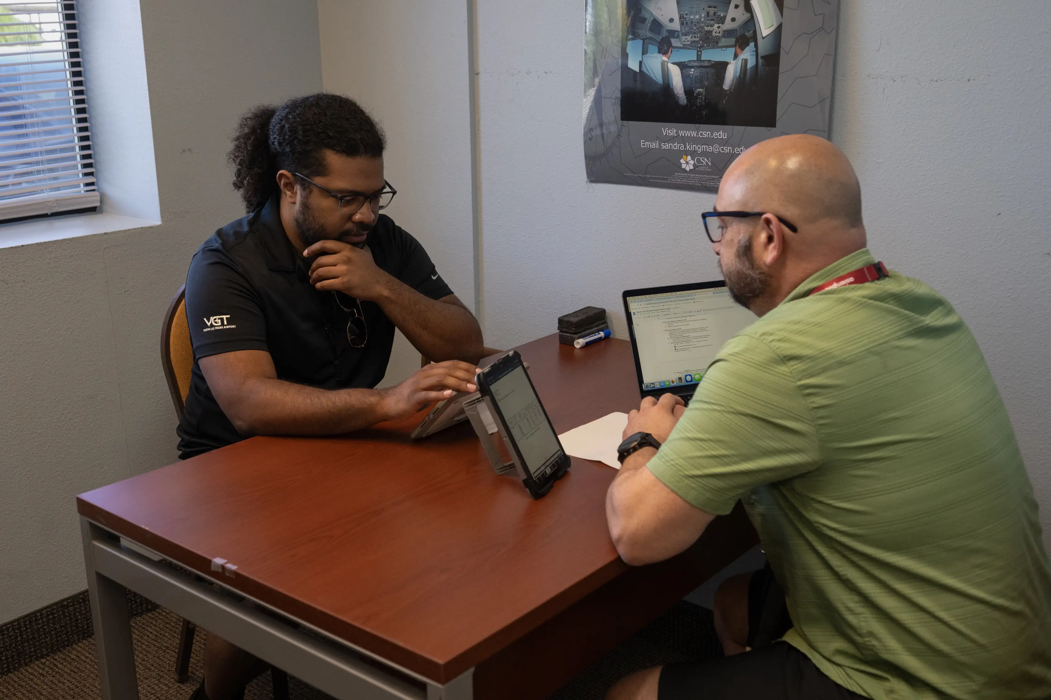 Student and CFI during a lesson in office