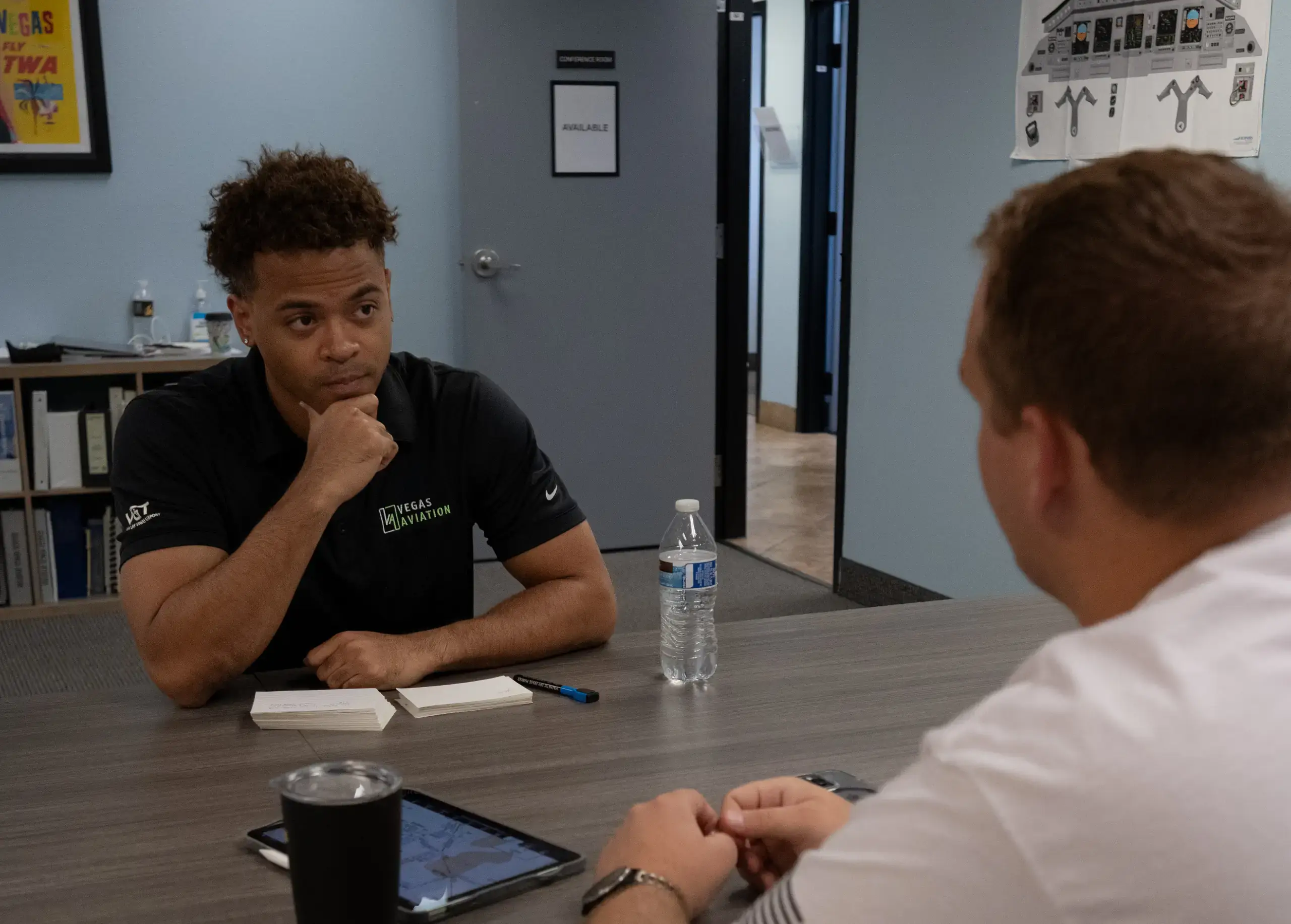 Flight instructor and student reviewing private pilot ground school material