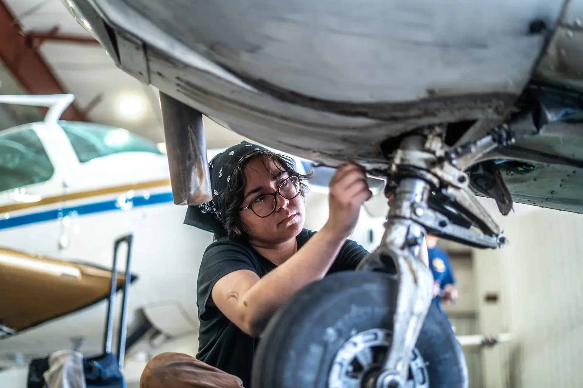 Mechanic working on aircraft landing gear
